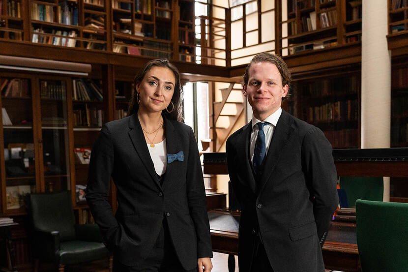 Jasmijn de Jong en Reinier Nijman staan in oude bibliotheek en kijken in de camera. Beiden gekleed in nette kleding